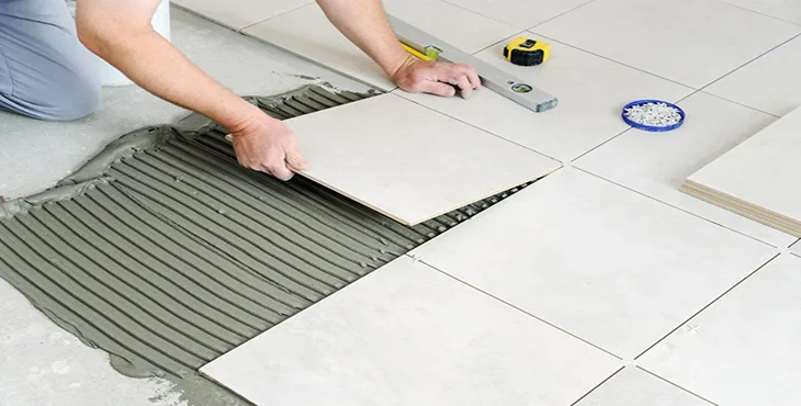 Golden Stone & Tile installer laying porcelain tile
