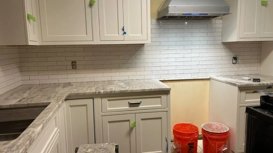 Subway tile backsplash behind a range hood in a Boston kitchen